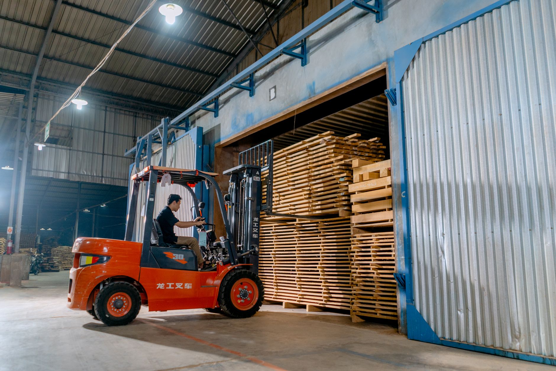 a man driving a forklift