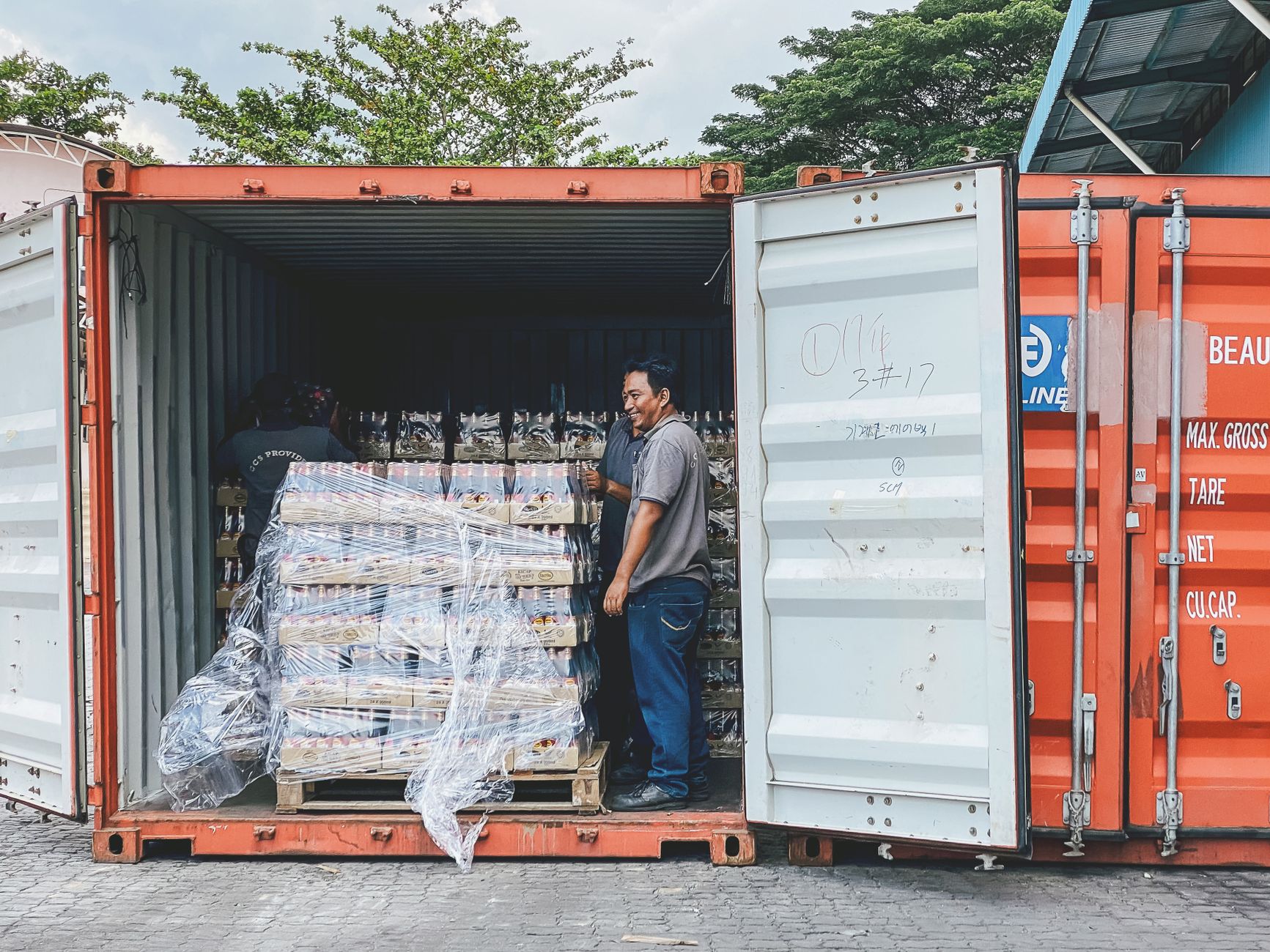 man standing in container with bottles