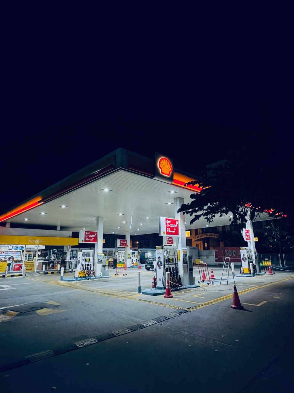 illuminated shell gas station at night in bengaluru