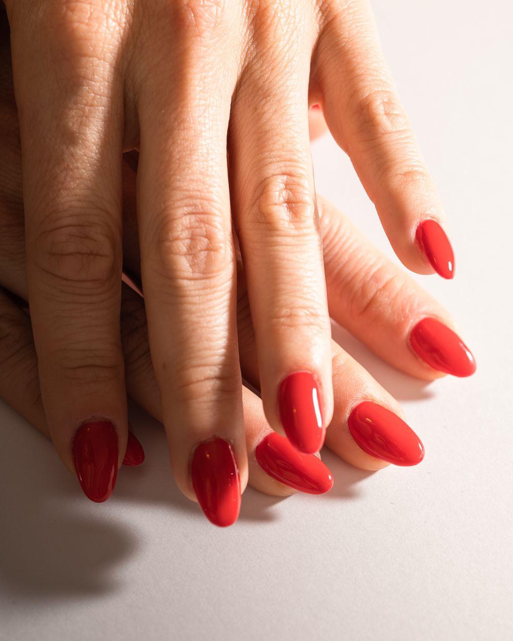 a hand with red painted nails
