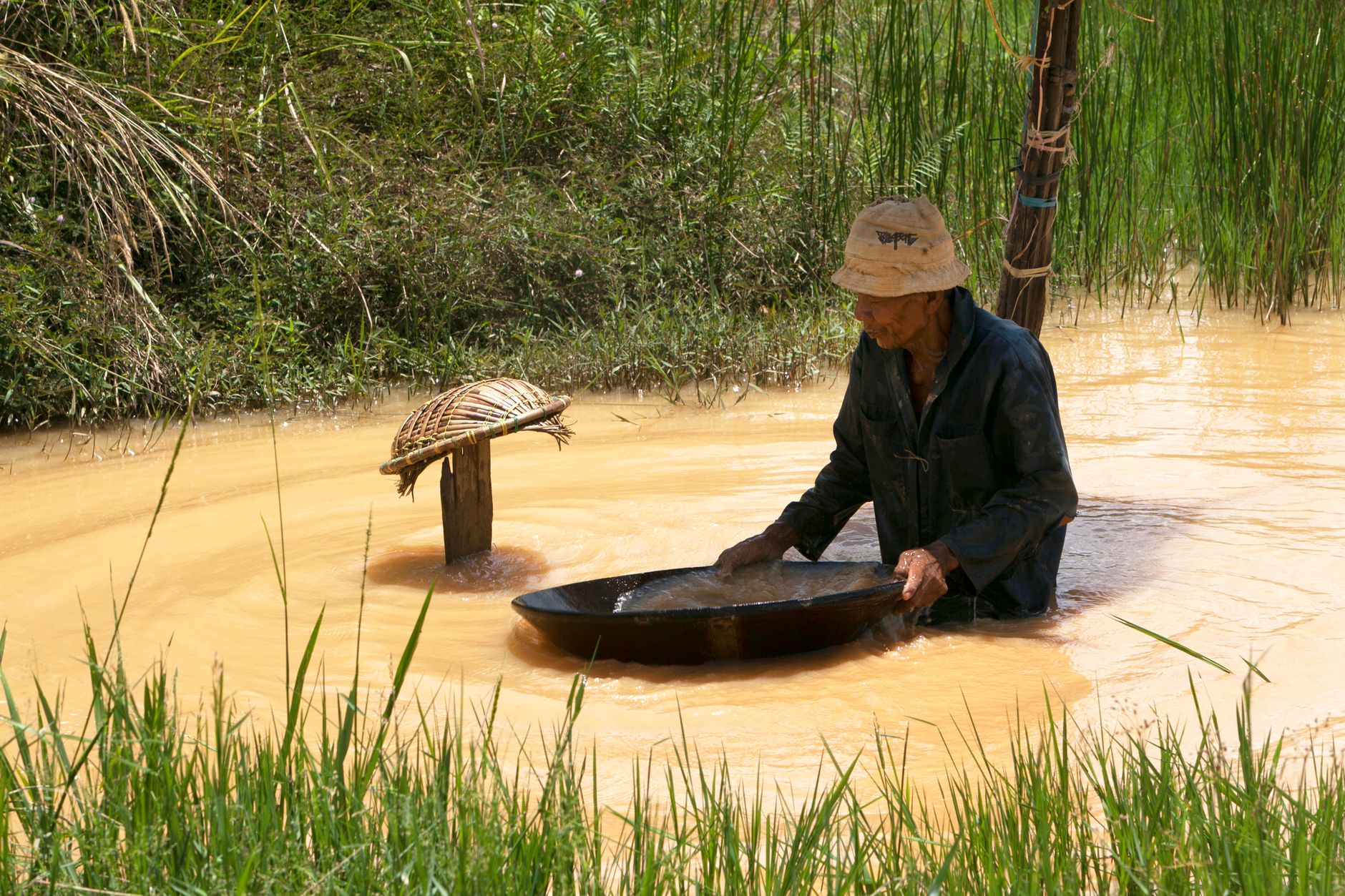 traditional gold panning in rural waterway